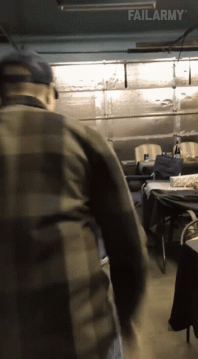 A Man In A Plaid Shirt Is Standing In A Garage With Failarmy Written On The Bottom Of The Screen GIF