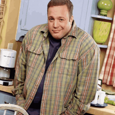 A Man In A Plaid Shirt Is Standing In Front Of A Coffee Maker GIF