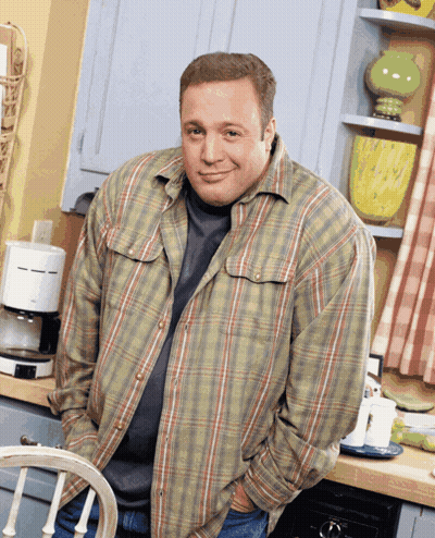 A Man In A Plaid Shirt Is Standing In Front Of A Coffee Maker GIF