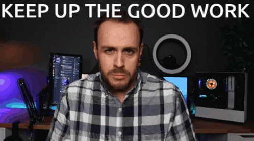 A Man In A Plaid Shirt Is Standing In Front Of A Computer Monitor With The Words " Keep Up The Good Work " Above Him GIF