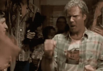 A Man In A Plaid Shirt Is Standing In Front Of A Group Of People . GIF