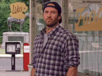 A Man In A Plaid Shirt Is Standing In Front Of Luke 'S GIF