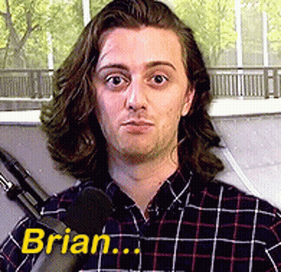 A Man In A Plaid Shirt Is Talking Into A Microphone And The Name Brian Is On The Bottom Right GIF