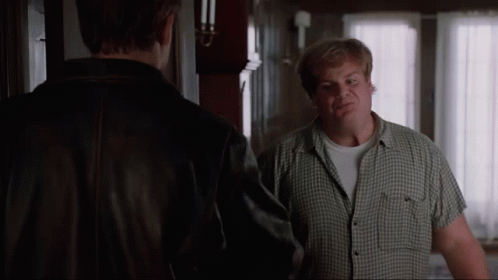 A Man In A Plaid Shirt Is Talking To Another Man In A Brown Jacket GIF