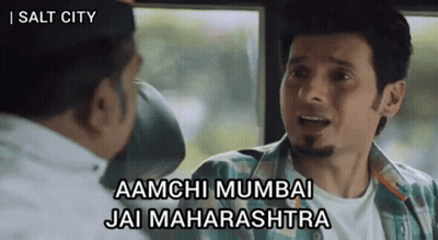 A Man In A Plaid Shirt Is Talking To Another Man With The Words Aamchi Mumbai Jai Maharashtra On The Bottom GIF