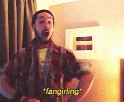 A Man In A Plaid Shirt Says " Fangirling " In A Room GIF