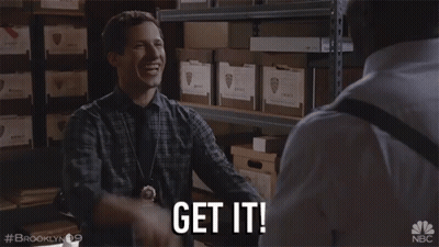 A Man In A Plaid Shirt Says Get It In A Warehouse GIF