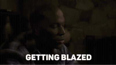 A Man In A Plaid Shirt Says Getting Blazed In A Dark Room GIF