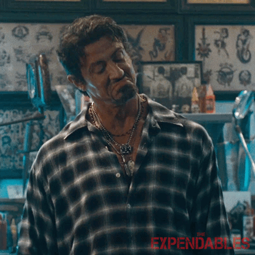 A Man In A Plaid Shirt Says " I 'M Good " In A Tattoo Shop GIF