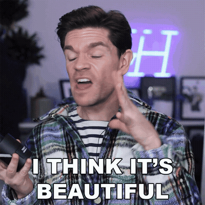 A Man In A Plaid Shirt Says " I Think It 'S Beautiful " While Holding A Camera GIF