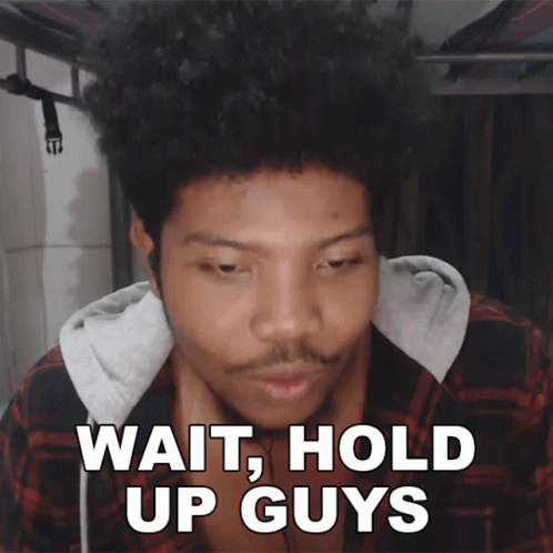 A Man In A Plaid Shirt Says Wait Hold Up Guys In White Letters GIF