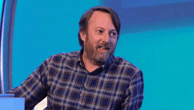 A Man In A Plaid Shirt Stands In Front Of A Purple Background That Says I Am Not Okay GIF