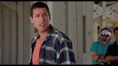 A Man In A Plaid Shirt Stands With His Arms Crossed In Front Of Two Other Men GIF