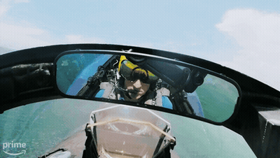 A Man In A Plane Is Reflected In A Rear View Mirror With The Word Prime On The Bottom GIF