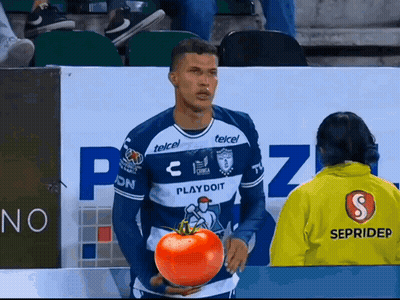 A Man In A Playdoit Jersey Holds A Tomato In His Hands GIF