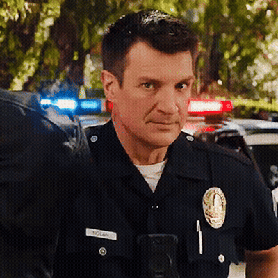 A Man In A Police Uniform Has The Name Nolan On His Badge GIF