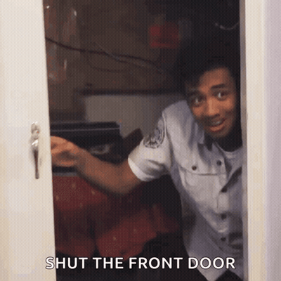 A Man In A Police Uniform Is Peeking Out Of A Door With The Words Shut The Front Door Below Him GIF