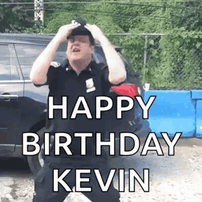 A Man In A Police Uniform Is Standing In Front Of A Car And Holding His Head While Saying `` Happy Birthday Kevin '' . GIF