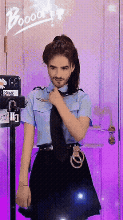A Man In A Police Uniform Is Standing In Front Of A Purple Door GIF