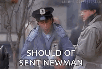 A Man In A Police Uniform Is Standing Next To Another Man And Holding A Box . GIF