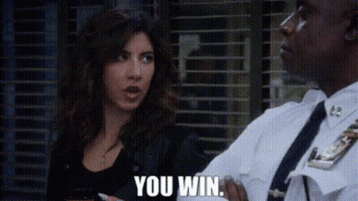 A Man In A Police Uniform Is Talking To A Woman Who Is Holding A Cell Phone . GIF