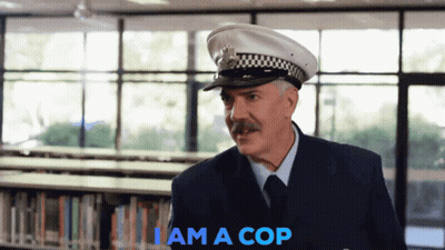 A Man In A Police Uniform Says I Am A Cop In Blue GIF