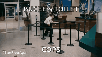 A Man In A Police Uniform Sits In A Line With The Words Bucee 'S Toilet Cops On The Bottom GIF