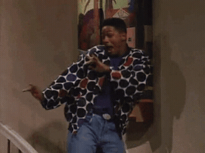 A Man In A Polka Dot Jacket Is Standing In Front Of A Painting GIF