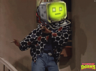 A Man In A Polka Dot Shirt Has A Computer Head On His Head And The Word Dorks Is On The Wall GIF