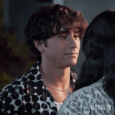 A Man In A Polka Dot Shirt Is Looking At A Woman In A Netflix Ad . GIF