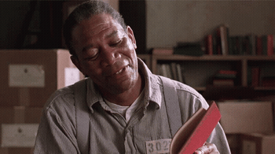 A Man In A Prison Uniform Has A Tag That Says 1302 GIF