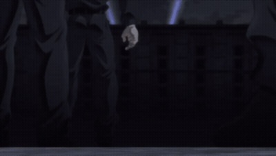 A Man In A Prison Uniform Is Laying On His Back In The Dark GIF