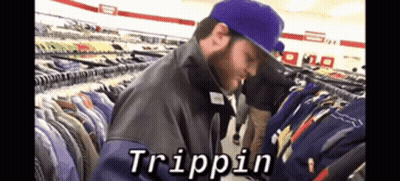 A Man In A Purple Hat Is Looking At Clothes In A Store And The Word Trippin Is On The Screen GIF