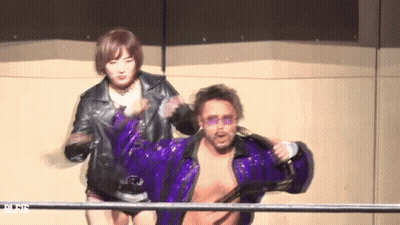A Man In A Purple Jacket Is Being Held By A Woman In A Black Jacket GIF