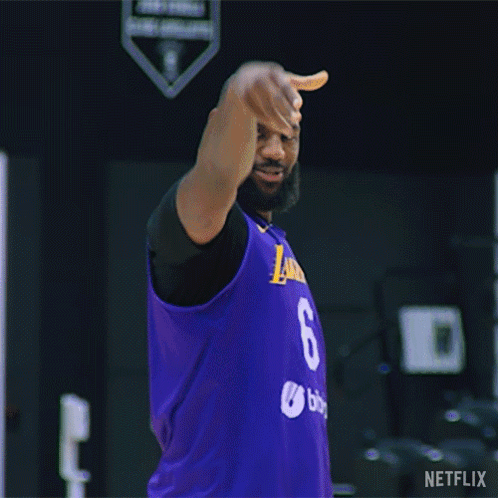 A Man In A Purple Jersey Is Standing On A Basketball Court Holding A Basketball . GIF