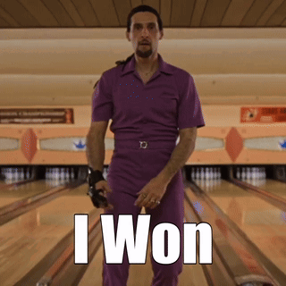 A Man In A Purple Jumpsuit Is Standing In A Bowling Alley With The Words I Won Above Him GIF