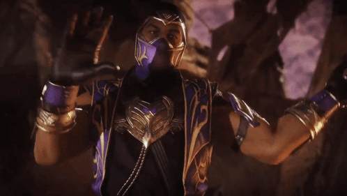 A Man In A Purple Mask Is Holding A Purple Weapon With The Letter M On It GIF