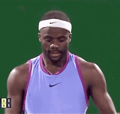 A Man In A Purple Nike Tank Top Is Drinking From A Bottle GIF