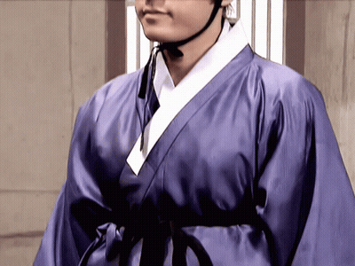 A Man In A Purple Robe With A Black Belt GIF