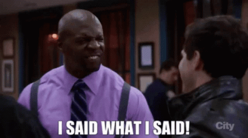 A Man In A Purple Shirt And Tie Says " I Said What I Said " To Another Man GIF