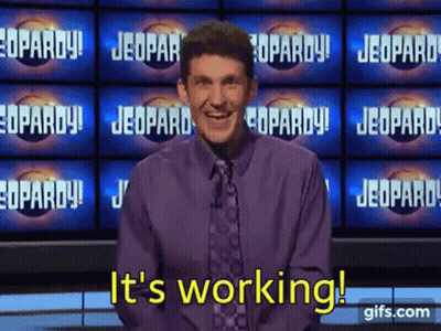 A Man In A Purple Shirt And Tie Says It 'S Working On A Jeopardy Show . GIF