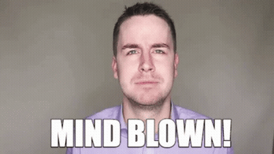 A Man In A Purple Shirt Is Blowing His Fist In The Air . GIF