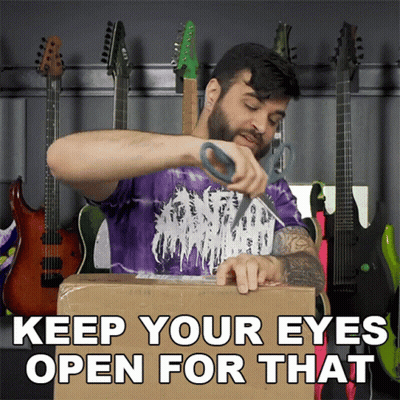A Man In A Purple Shirt Is Cutting A Cardboard Box With The Words " Keep Your Eyes Open For That " GIF