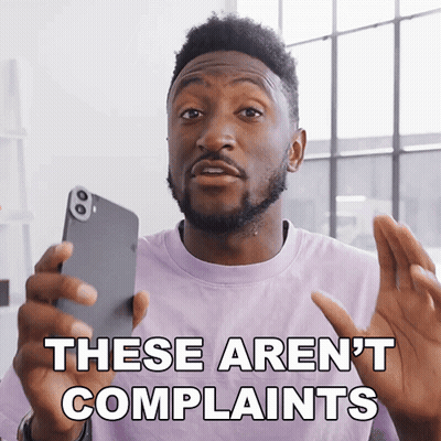 A Man In A Purple Shirt Is Holding A Cell Phone And Says These Aren 'T Complaints GIF