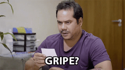 A Man In A Purple Shirt Is Holding A Piece Of Paper That Says " Gripe " GIF