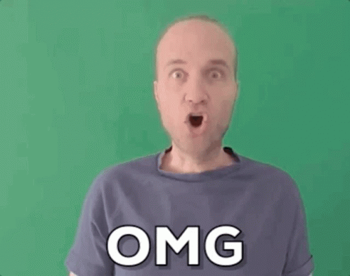 A Man In A Purple Shirt Is Making A Funny Face And The Word Omg Is On His Shirt . GIF