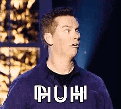 A Man In A Purple Shirt Is Making A Funny Face With The Word Huh Written On His Chest . GIF