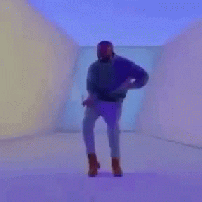 A Man In A Purple Shirt Is Playing Tennis On A Tennis Court GIF