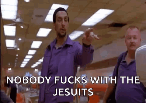 A Man In A Purple Shirt Is Pointing At Another Man In A Purple Shirt . GIF