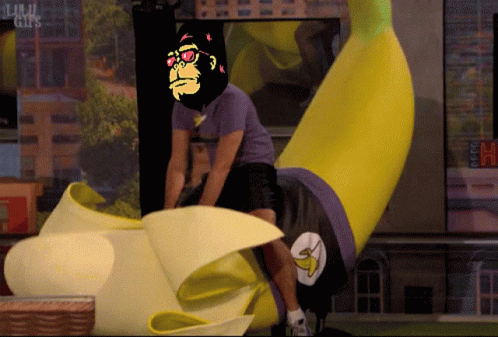 A Man In A Purple Shirt Is Riding A Banana With A Picture Of A Gorilla On His Head GIF